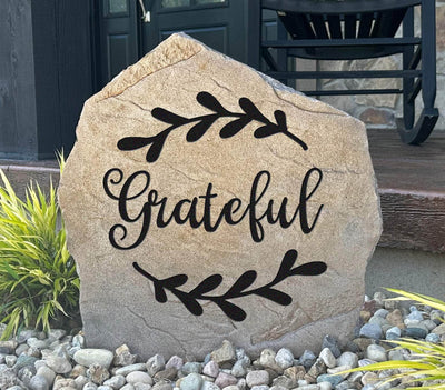 Grateful engraved stone with decorative leaf design for outdoor landscaping