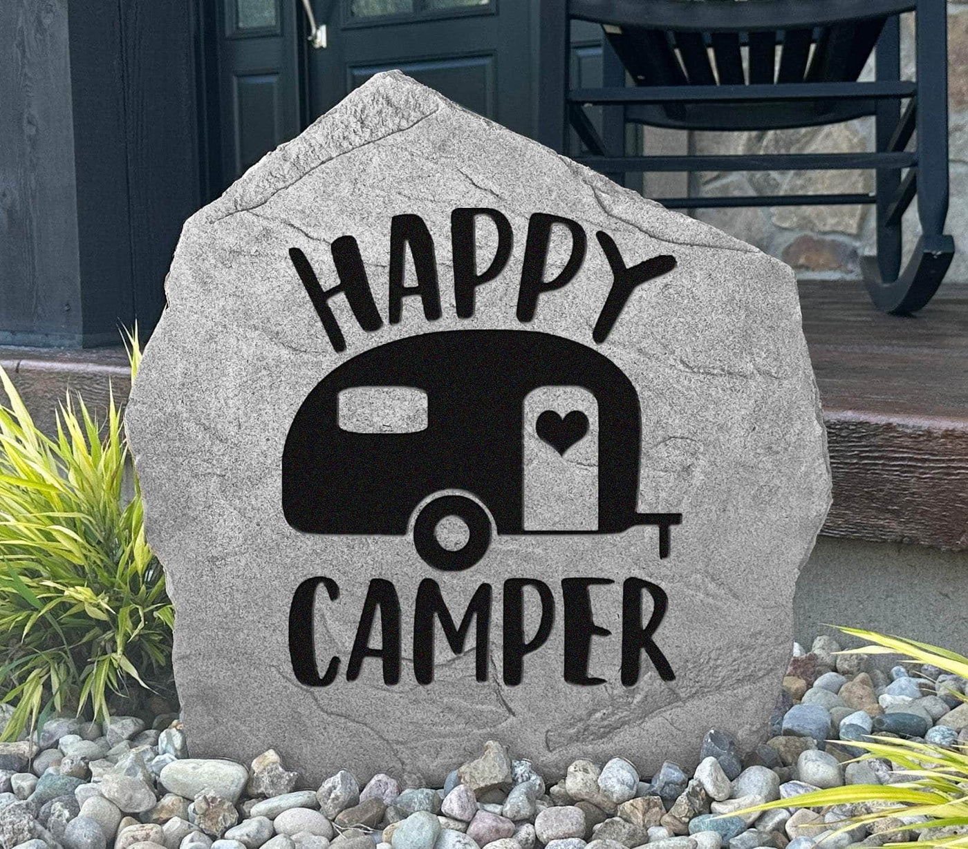 Happy Camper engraved stone with camper design for outdoor decoration.