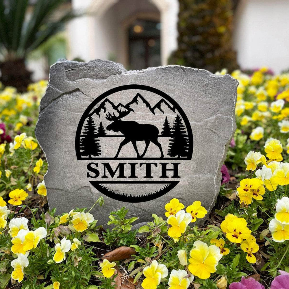 Personalized Moose Monogram Stone handcrafted in the USA with custom engraving and nature-inspired artwork. This decorative garden stone enhances front yards, landscape beds, and cabin entrances with rustic style.