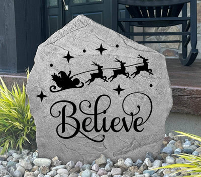 Christmas yard décor stone featuring Santa and reindeer