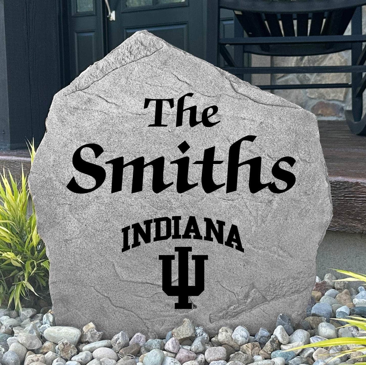 Custom Indiana University Name Stone displayed in a landscaped flower bed, showcasing personalized family lettering and officially licensed Indiana Hoosiers artwork. This decorative outdoor stone creates a beautiful focal point for alumni homes and Hoosiers fans.