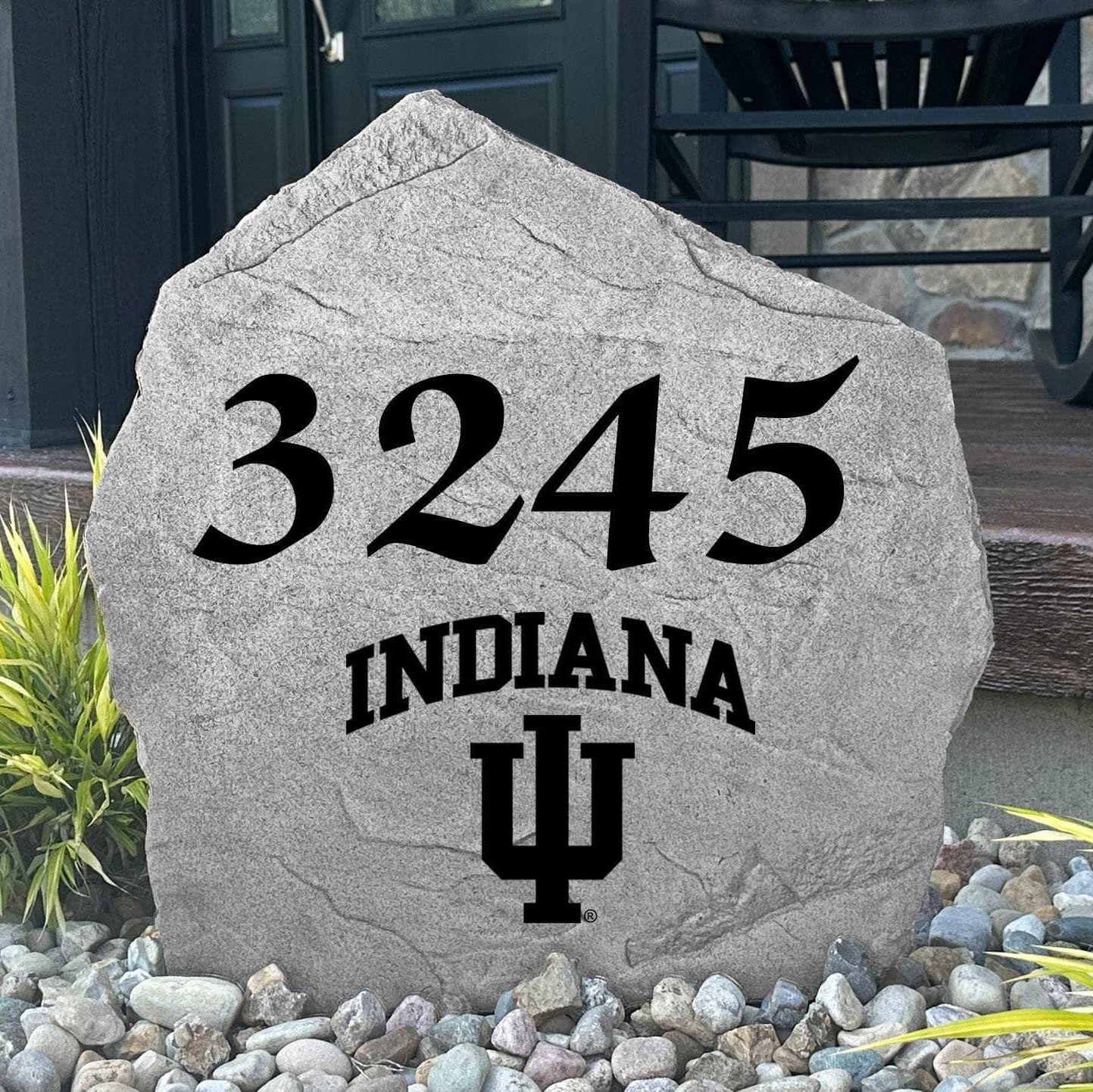 Custom Indiana University Address Stone displayed in a landscaped flower bed with personalized house numbers and officially licensed Indiana Hoosiers artwork. This engraved address marker creates a striking focal point for alumni homes and devoted Hoosiers fans.