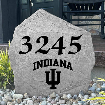Custom Indiana University Address Stone displayed in a landscaped flower bed with personalized house numbers and officially licensed Indiana Hoosiers artwork. This engraved address marker creates a striking focal point for alumni homes and devoted Hoosiers fans.