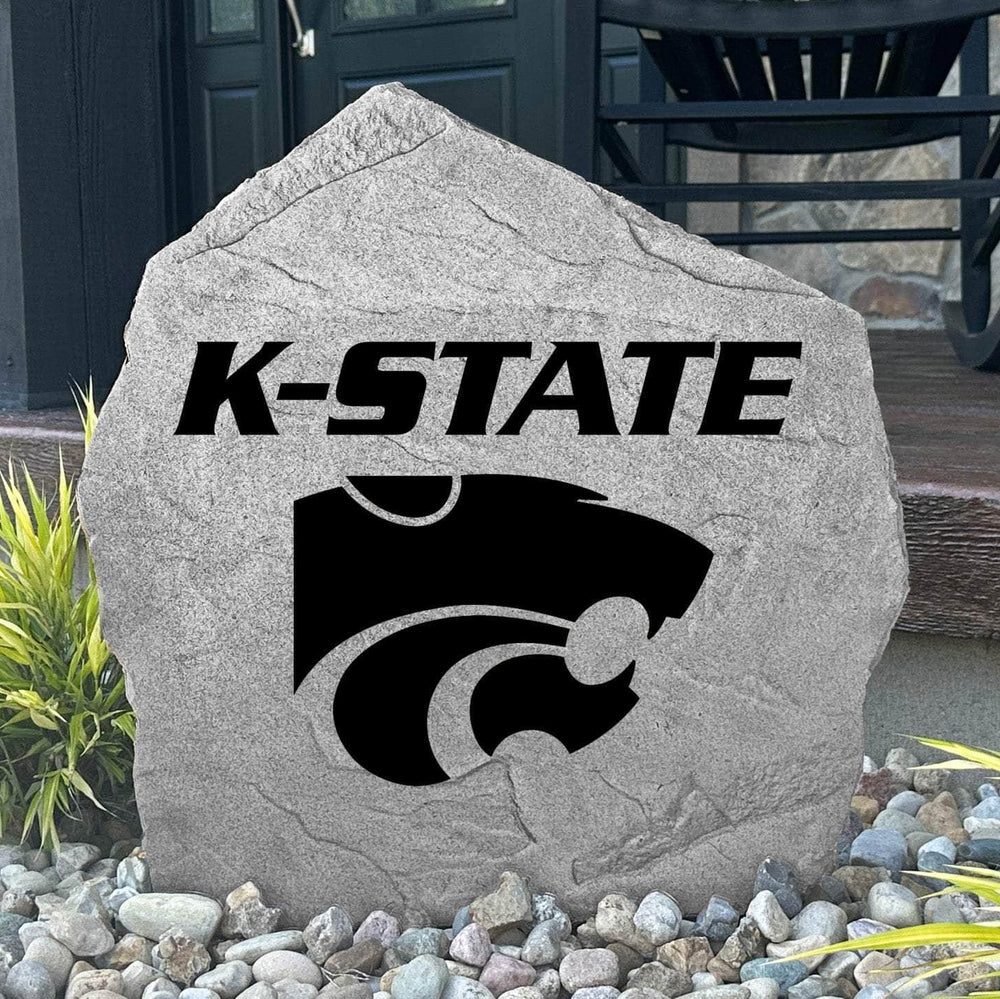 Custom Kansas State Wildcats Logo Stone displayed in a landscaped flower bed, showcasing officially licensed team artwork permanently engraved into the stone. This outdoor accent creates a beautiful focal point for alumni homes and devoted Wildcats fans.