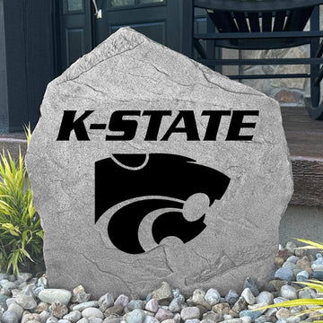 Custom Kansas State Wildcats Logo Stone displayed in a landscaped flower bed, showcasing officially licensed team artwork permanently engraved into the stone. This outdoor accent creates a beautiful focal point for alumni homes and devoted Wildcats fans.