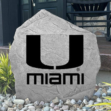 Custom Miami Hurricanes Logo Stone displayed in a landscaped flower bed, showcasing officially licensed team artwork permanently engraved into the stone. This outdoor accent creates a beautiful focal point for alumni homes and devoted Hurricanes fans.