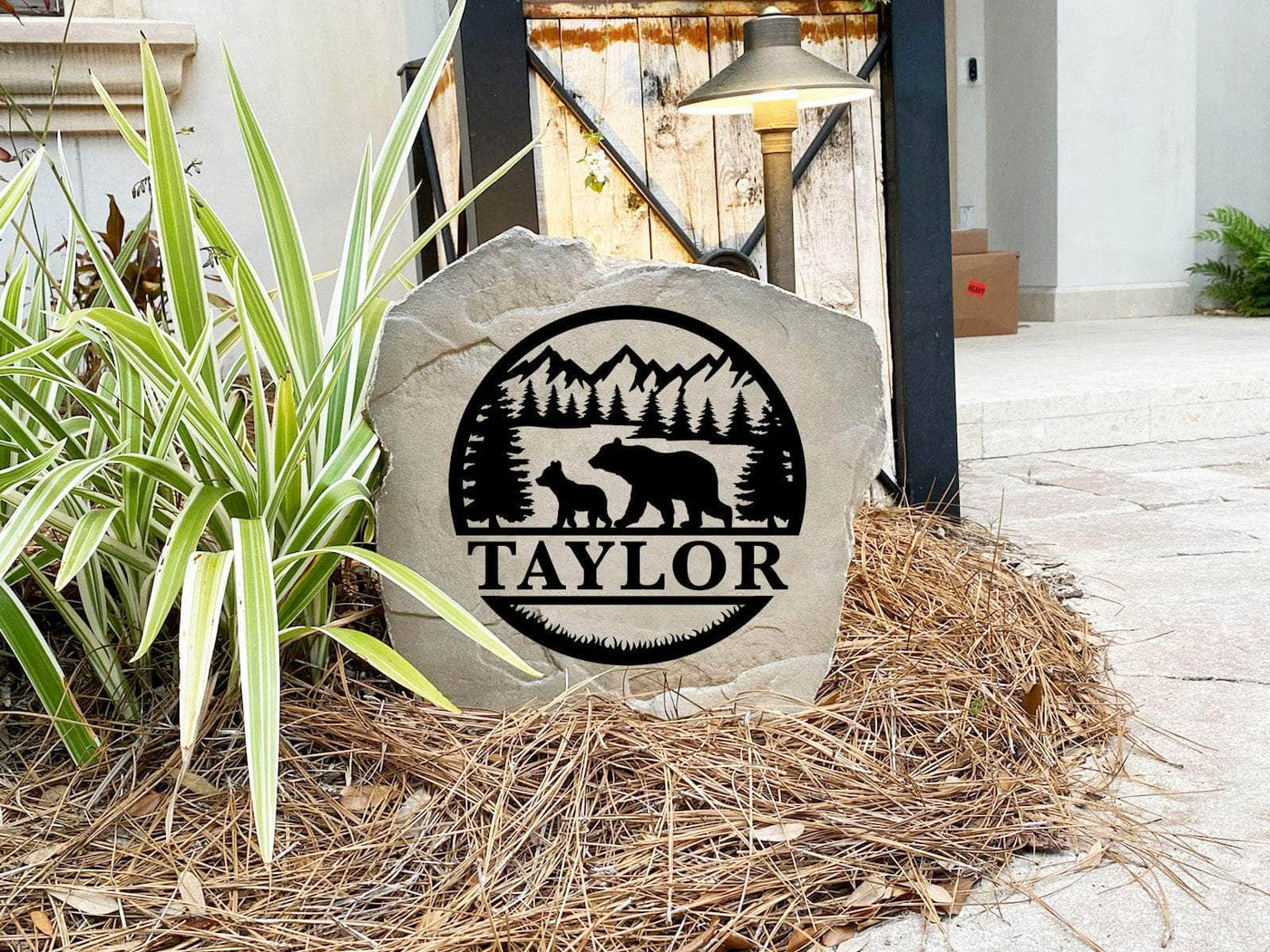 Custom wilderness stone featuring mountains, trees, and family name for cabin or yard