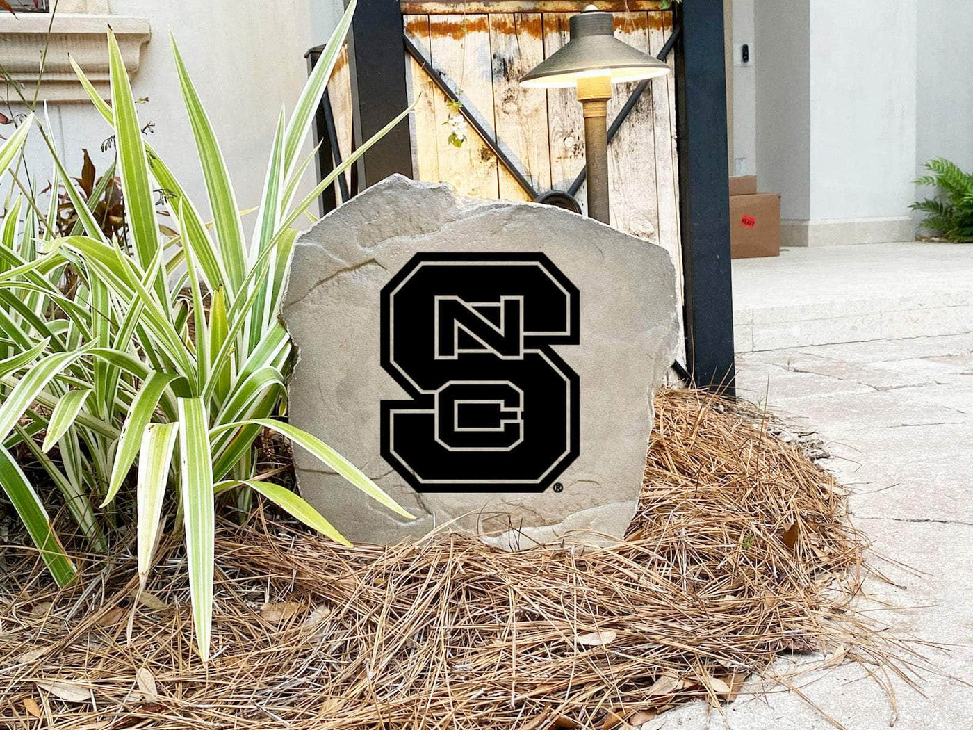 Custom stone marker with engraved NC State Wolfpack team logo