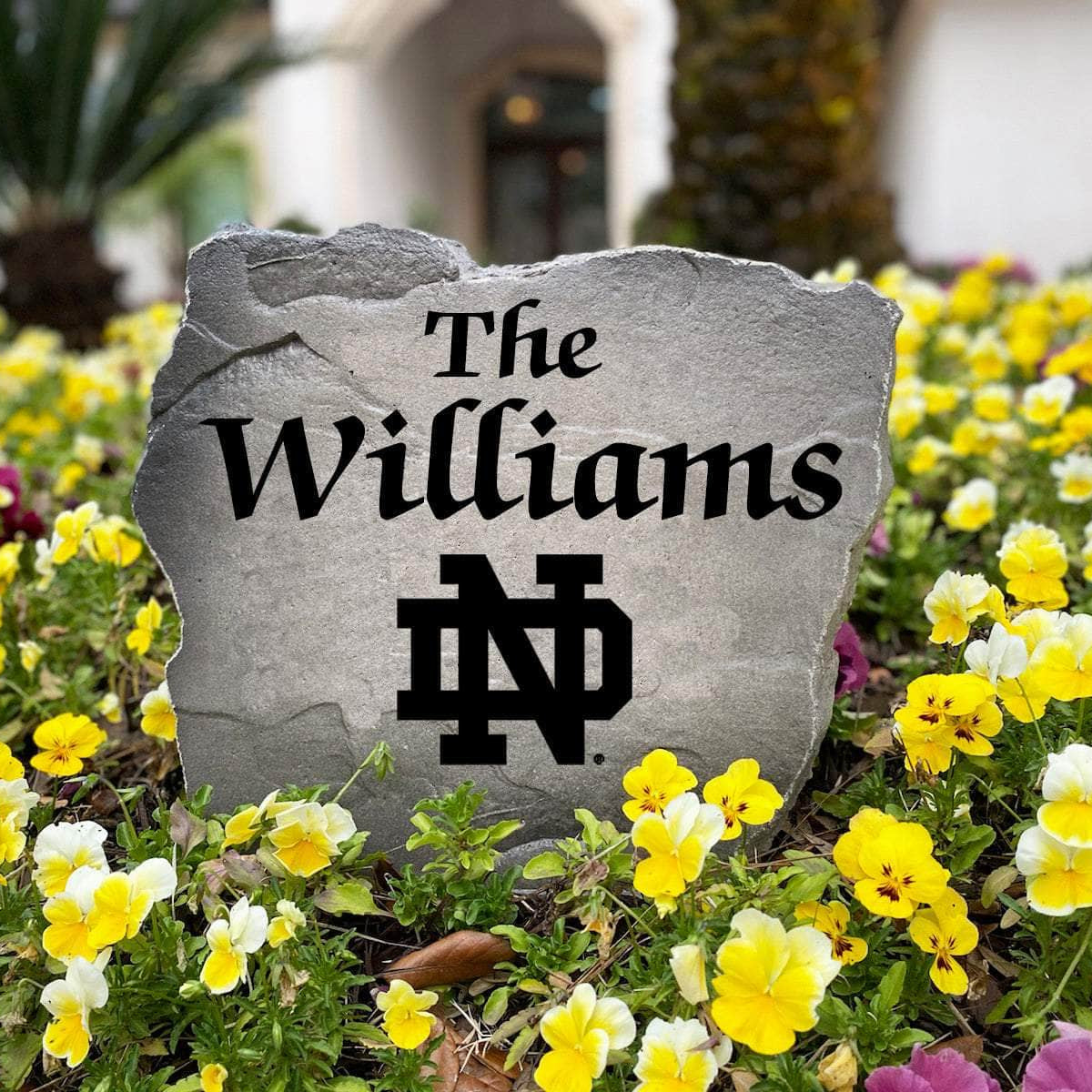 Officially licensed Notre Dame Fighting Irish Name Stone handcrafted in the USA with custom family engraving and detailed team artwork. This decorative garden stone enhances landscape beds, patios, and outdoor living spaces with lasting beauty and school spirit.