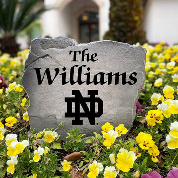 Officially licensed Notre Dame Fighting Irish Name Stone handcrafted in the USA with custom family engraving and detailed team artwork. This decorative garden stone enhances landscape beds, patios, and outdoor living spaces with lasting beauty and school spirit.