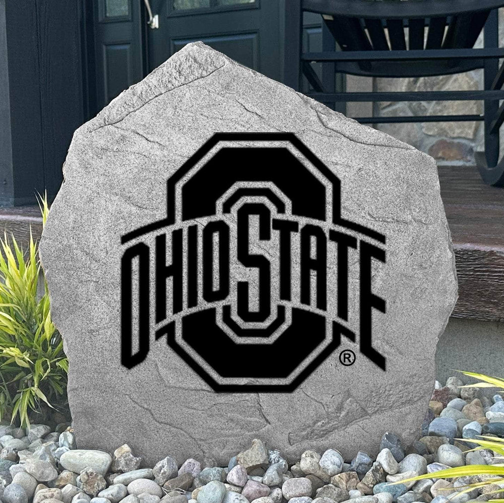Custom Ohio State Buckeyes Logo Stone displayed in a landscaped flower bed, showcasing officially licensed team artwork permanently engraved into the stone. This outdoor accent creates a striking focal point for alumni homes and devoted Buckeyes fans.