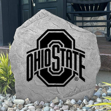 Custom Ohio State Buckeyes Logo Stone displayed in a landscaped flower bed, showcasing officially licensed team artwork permanently engraved into the stone. This outdoor accent creates a striking focal point for alumni homes and devoted Buckeyes fans.