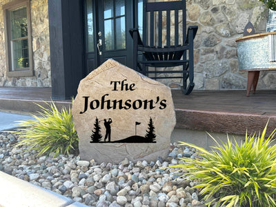 Unique golf landscape stone with trees, flag, and golfer design.