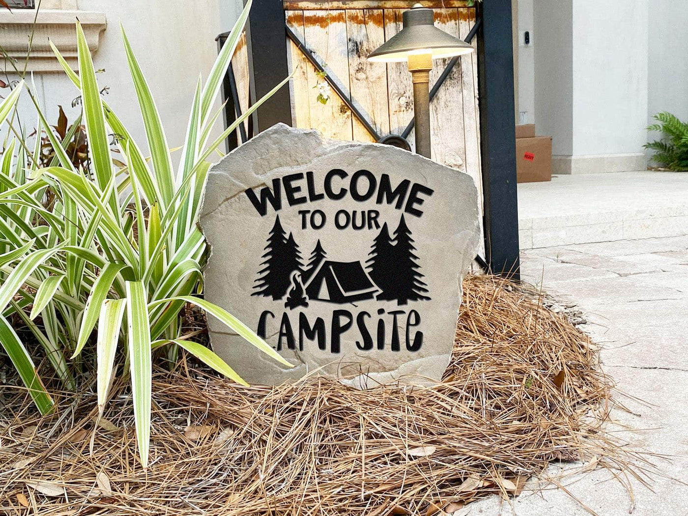 Decorative rock with welcome to our campsite message for RV or tent campers