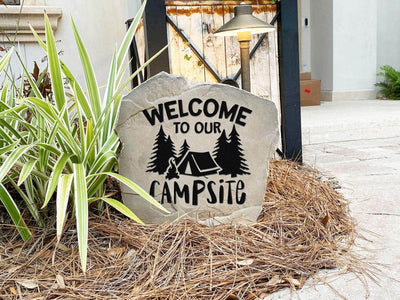 Decorative rock with welcome to our campsite message for RV or tent campers