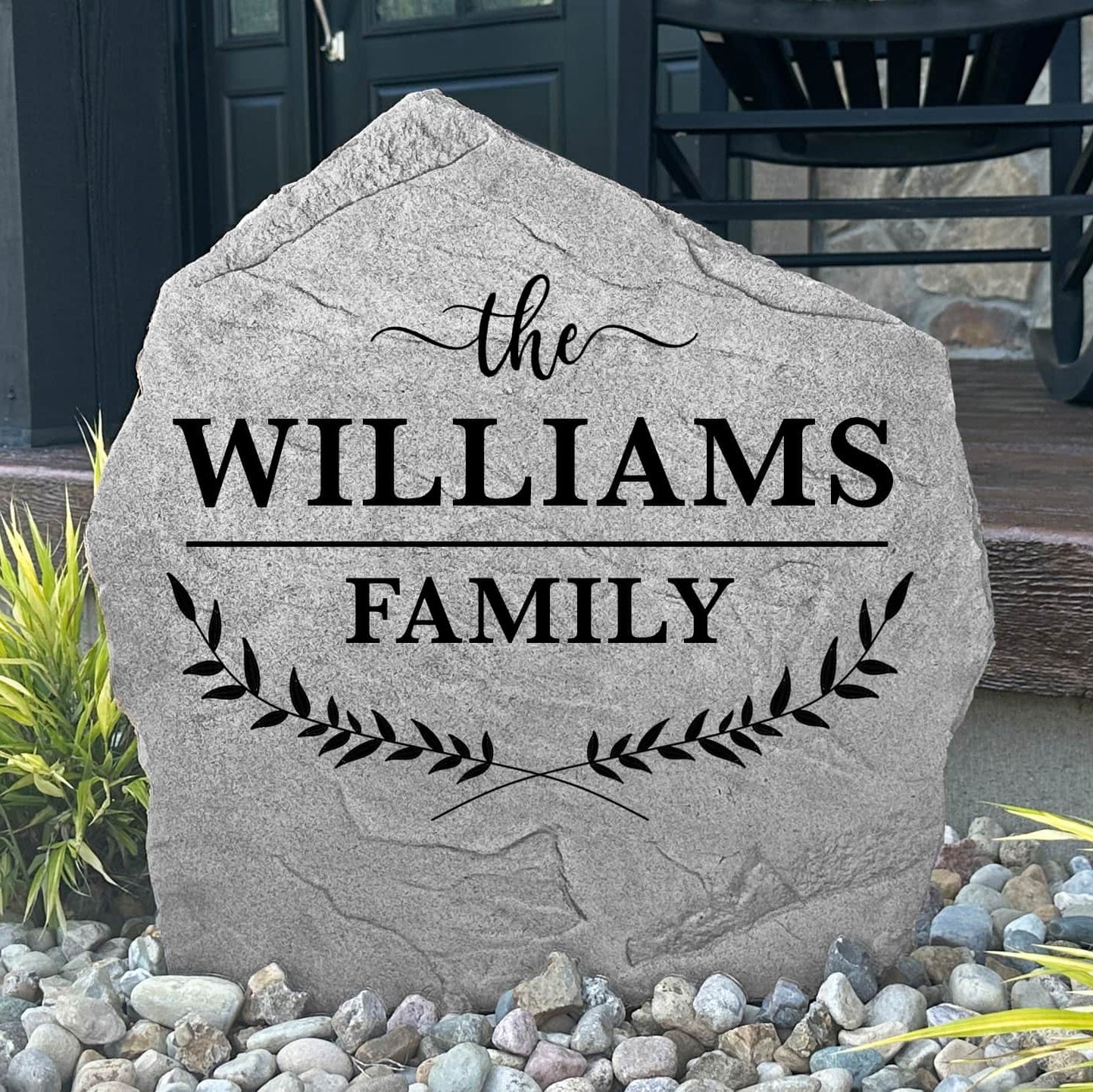 Custom Family Name Leaf Stone displayed in a landscaped garden, showcasing personalized engraving and nature-inspired leaf details. This engraved outdoor sign creates a beautiful focal point for walkways and home entrances.