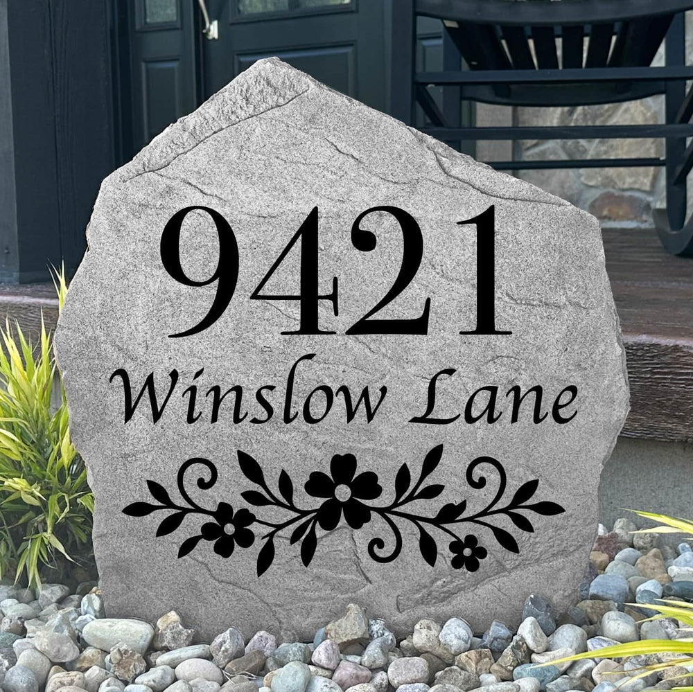 Personalized Floral Address Stone featuring custom house numbers and elegant floral engraving, permanently carved into the stone surface for lasting durability. Displayed in a landscaped front yard, this engraved address stone enhances curb appeal and provides a beautiful, easy-to-read address marker for gardens, walkways, driveways, and home entryways.