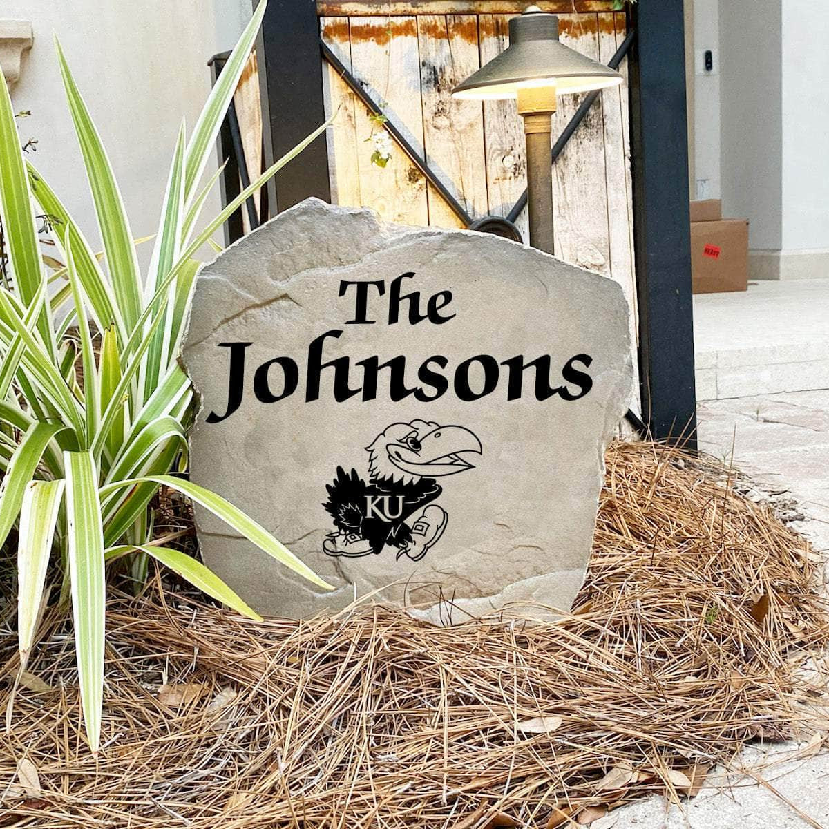 Custom University of Kansas Jayhawks Name Stone featuring the official university logo and your personalized family name. A beautiful landscape accent for gardens, patios, front entryways, and flower beds.