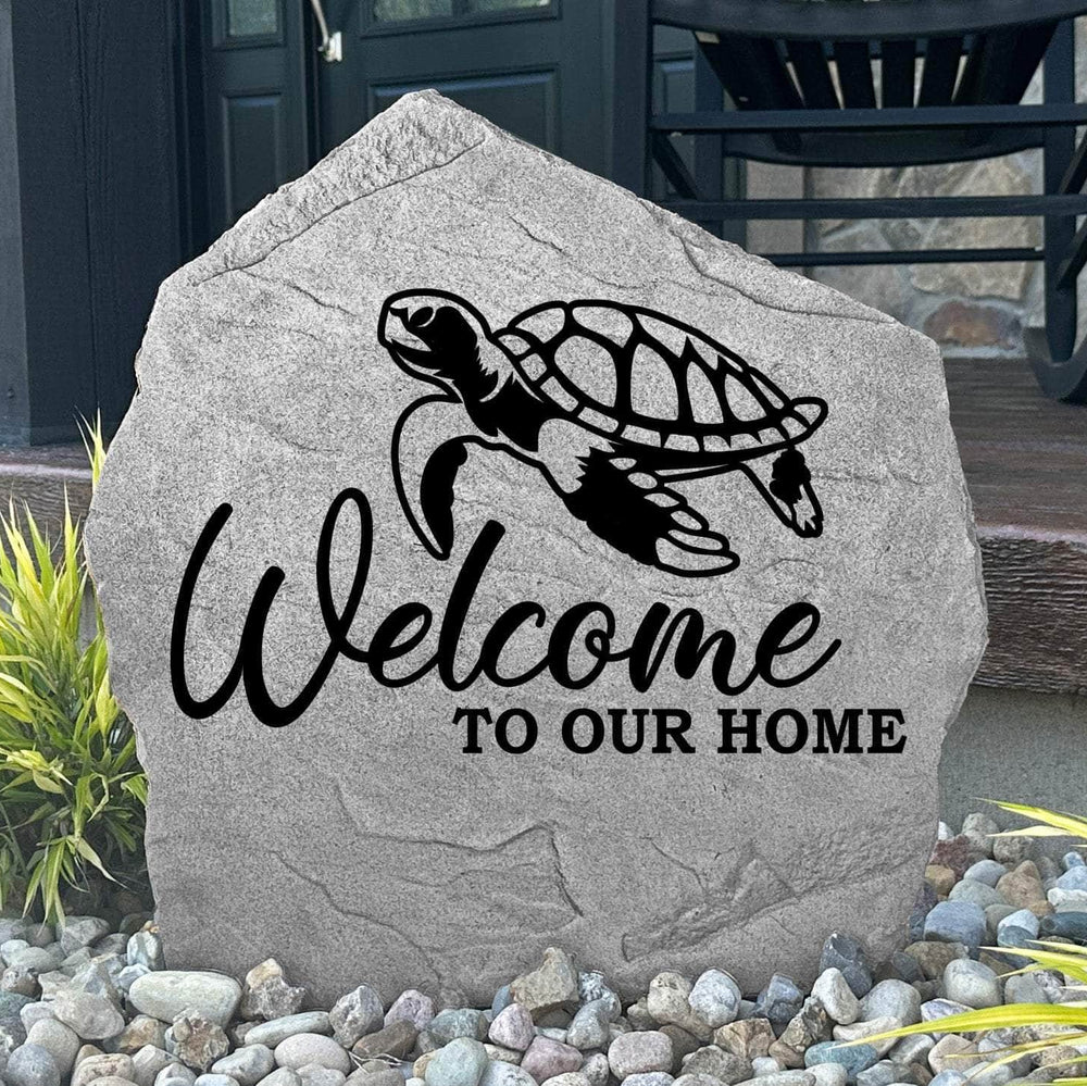 Custom Welcome Sea Turtle Stone displayed in a landscaped flower bed, showcasing detailed sea turtle artwork and a warm welcome message. This engraved outdoor stone creates a beautiful focal point for walkways and coastal-inspired landscapes.