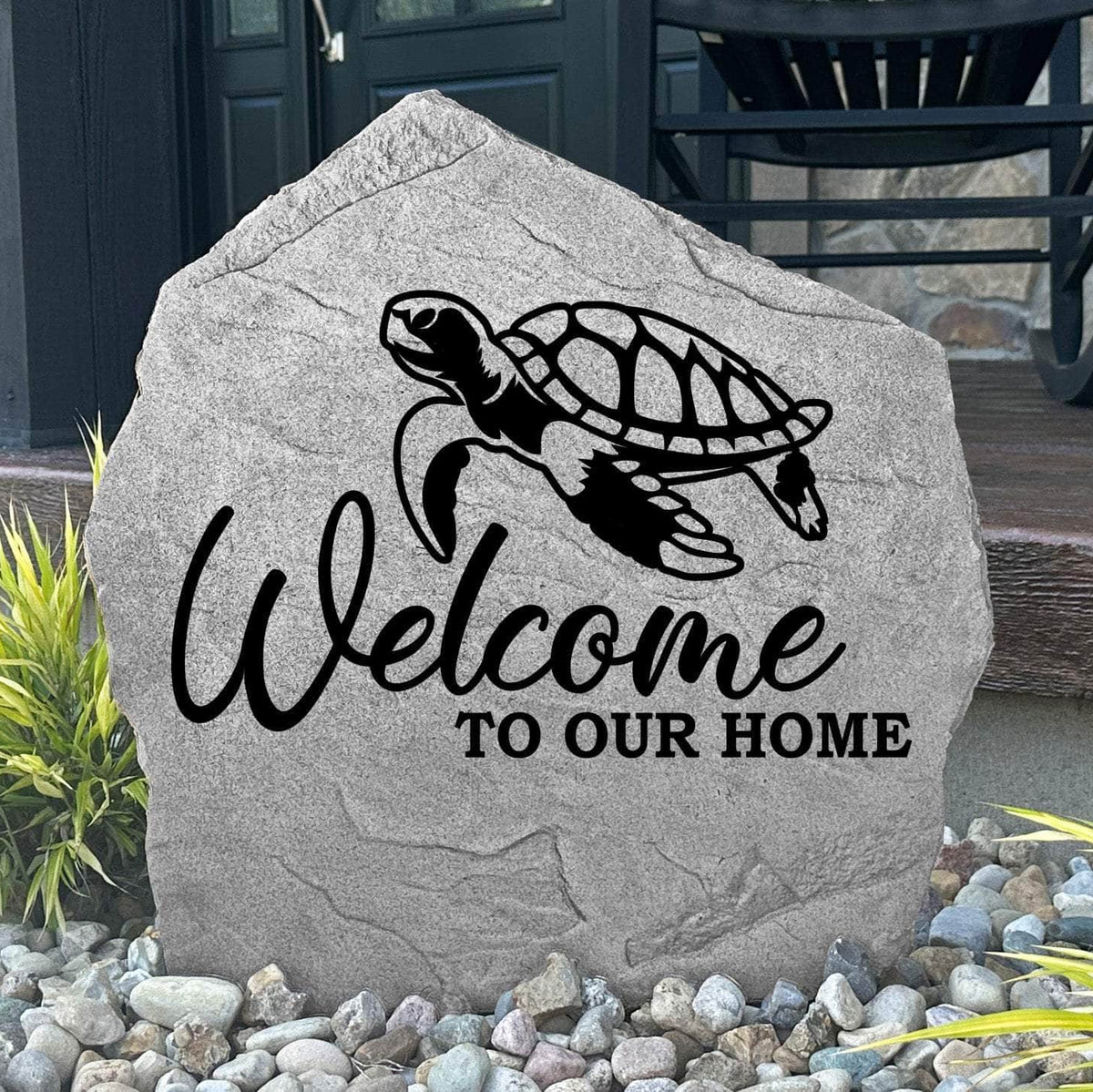Custom Welcome Sea Turtle Stone displayed in a landscaped flower bed, showcasing detailed sea turtle artwork and a warm welcome message. This engraved outdoor stone creates a beautiful focal point for walkways and coastal-inspired landscapes.