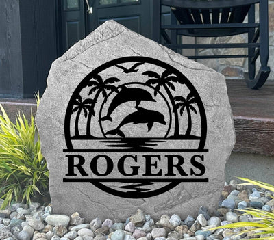 Custom outdoor rock with dolphins and island scene, ideal for landscaping or gifting.