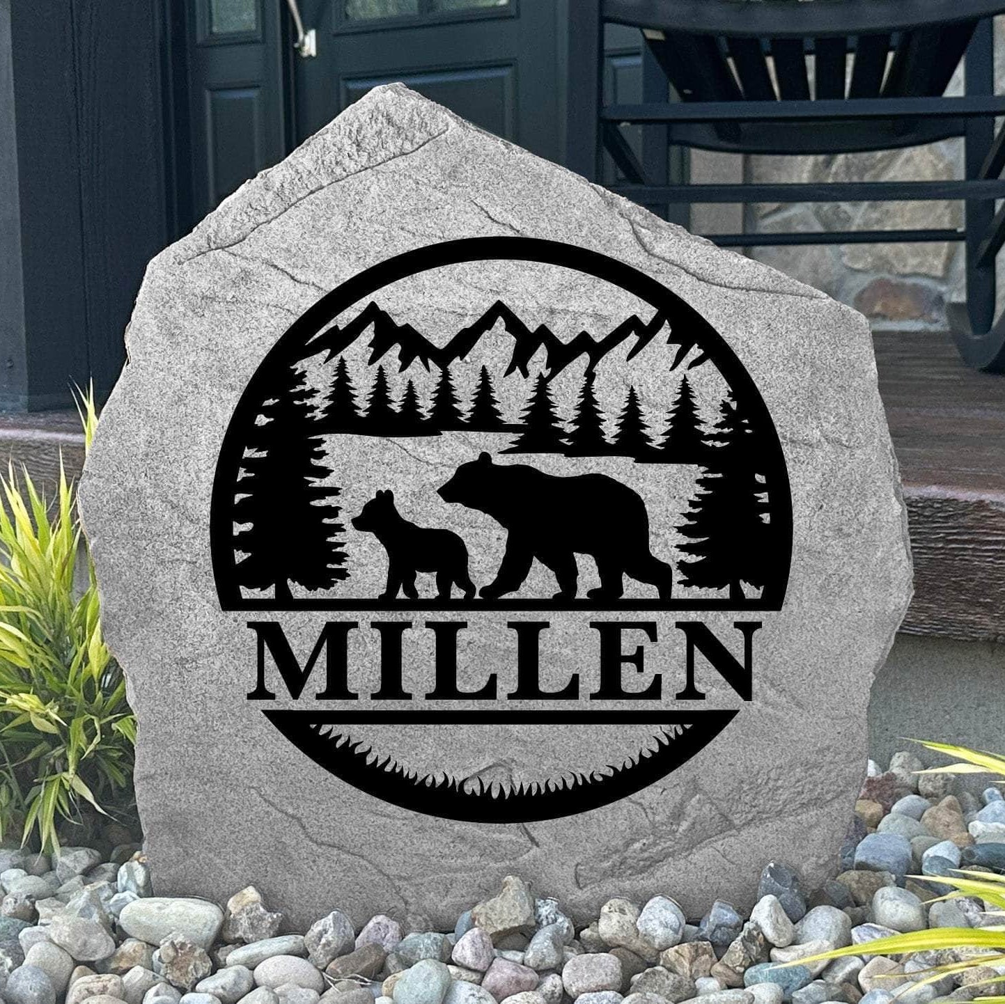 Custom Bear Monogram Stone displayed in a landscaped flower bed, showcasing personalized engraving and wildlife-inspired bear details. This engraved outdoor stone creates a striking focal point for cabins, gardens, and woodland homes.