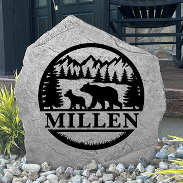 Custom Bear Monogram Stone displayed in a landscaped flower bed, showcasing personalized engraving and wildlife-inspired bear details. This engraved outdoor stone creates a striking focal point for cabins, gardens, and woodland homes.