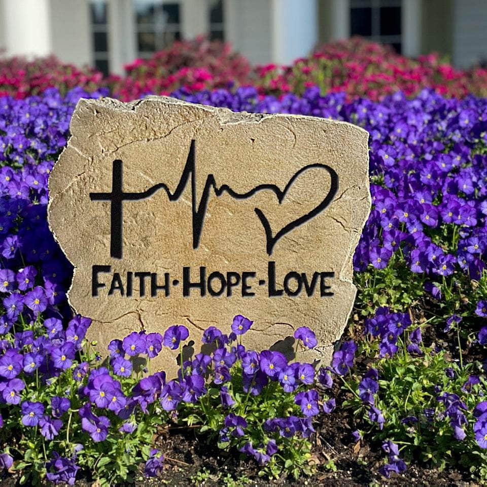Inspirational landscape stone featuring the words "Faith Hope Love," creating a meaningful focal point for flower beds, walkways, and prayer gardens.