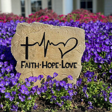 Inspirational landscape stone featuring the words "Faith Hope Love," creating a meaningful focal point for flower beds, walkways, and prayer gardens.