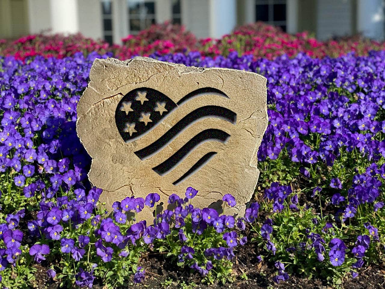 Outdoor decorative stone with engraved American flag heart design