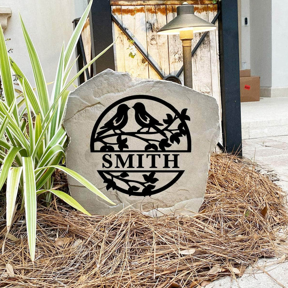 Engraved Love Birds Monogram Stone nestled among colorful flowers and greenery, bringing nature-inspired beauty and personalized charm to front yard landscapes and outdoor living spaces.