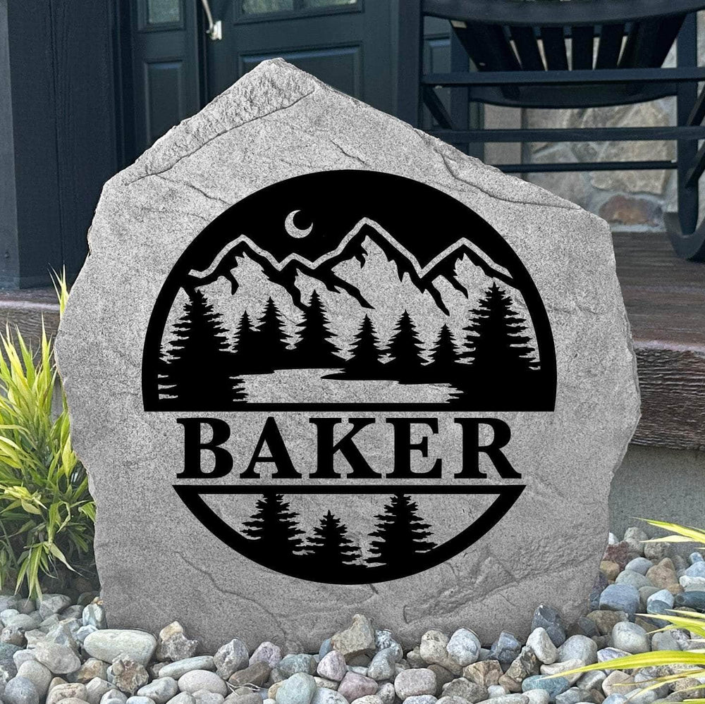 Custom Forest Monogram Stone displayed in a landscaped flower bed, showcasing personalized engraving and nature-inspired forest details. This engraved outdoor stone creates a beautiful focal point for gardens, walkways, and cabin entrances.
