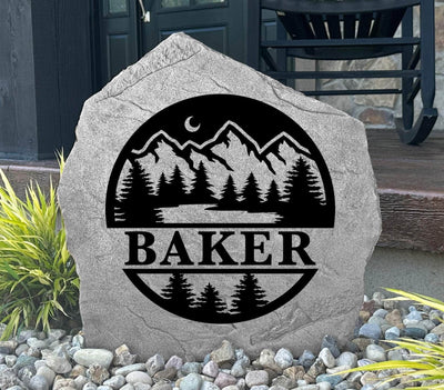 Custom engraved stone with nature scene and family name, ideal for garden or cabin.