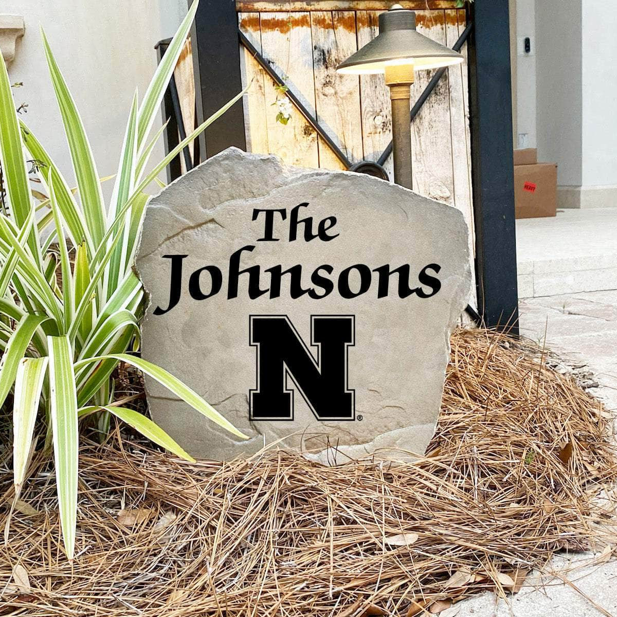 Decorative University of Nebraska lawn stone customized with your surname, creating a bold collegiate accent for gardens, walkways, patios, and entryways.