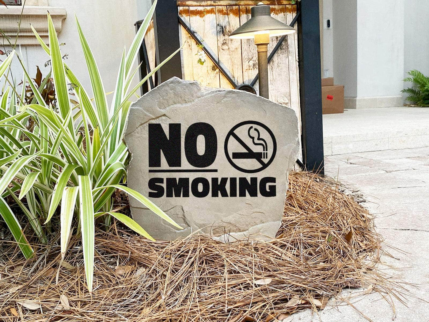 Rustic landscaping rock featuring No Smoking engraving