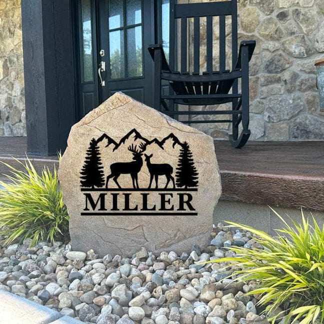 Decorative Deer Mountain Name Stone featuring custom family names and scenic wildlife artwork permanently engraved into the stone surface. Perfect for cabins, lodges, patios, and gardens, this outdoor stone adds timeless rustic appeal.