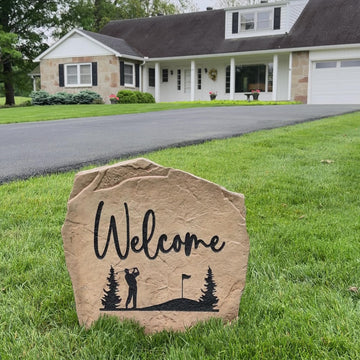 Engraved Welcome Golf Stone nestled among colorful flowers and greenery, bringing golf course charm and timeless style to front yard landscaping. Perfect for patios, gardens, and outdoor living spaces.