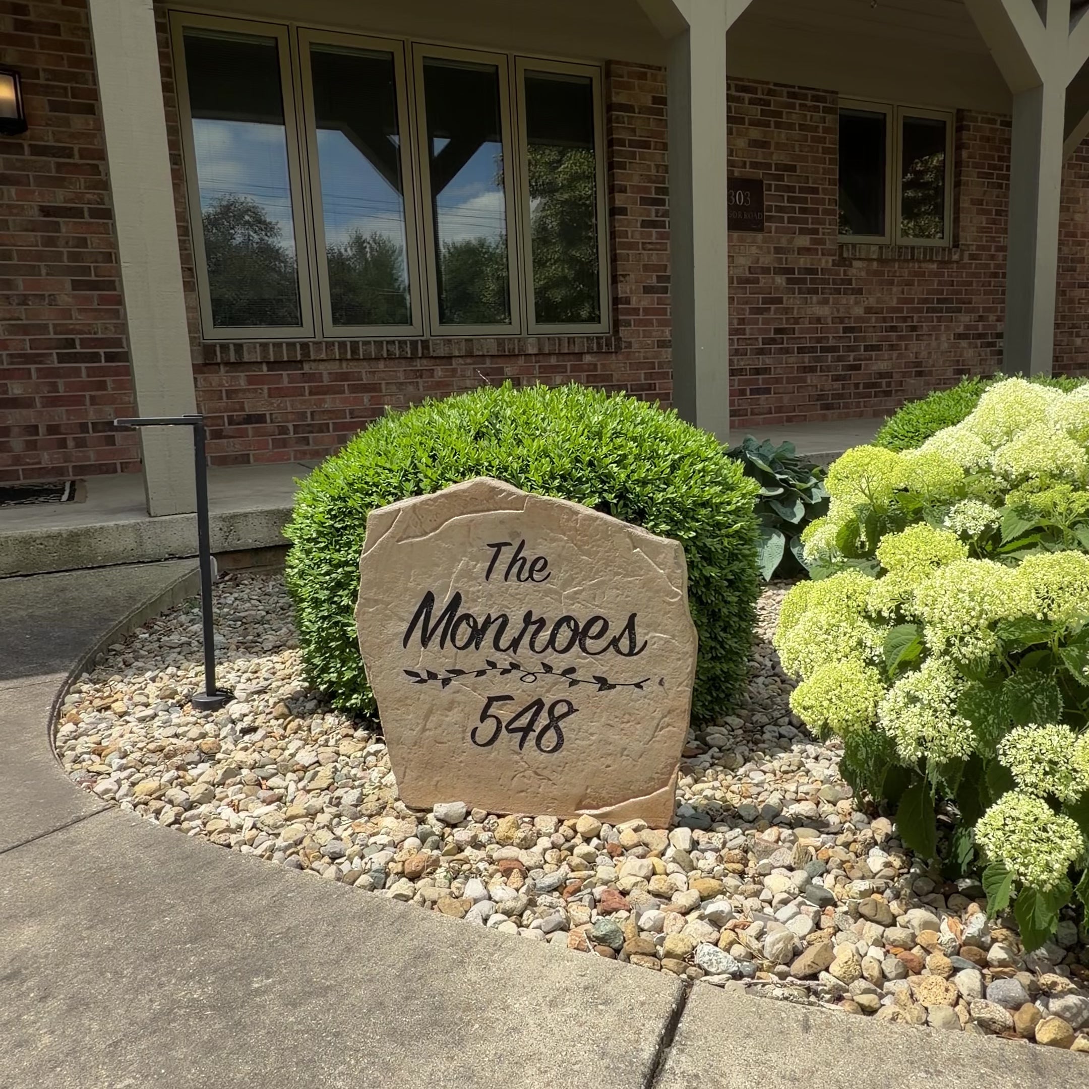 Custom engraved Name and Address stone featuring family name and house numbers in an elegant outdoor setting.