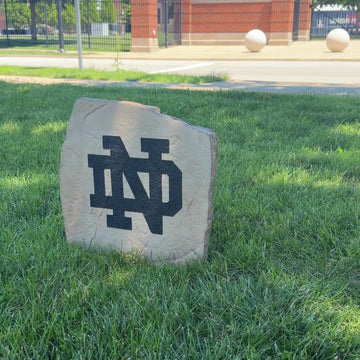 Officially licensed University of Notre Dame Logo Stone featuring the iconic Fighting Irish logo engraved directly into the stone surface. This decorative garden stone adds school spirit and curb appeal to front yards, patios, gardens, and entryways.