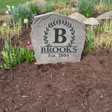 Personalized Vine Monogram stone displayed in elegant front yard landscaping for added curb appeal