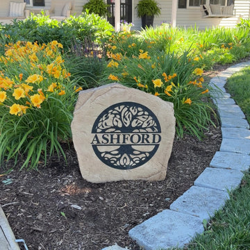 Gracefully nestled among flowers and greenery, the Tree of Life Monogram Stone showcases a personalized initial surrounded by an intricate tree design symbolizing family, strength, and growth. Its elegant engraving and timeless style create a meaningful focal point that enhances the beauty of any garden, entryway, or landscape.