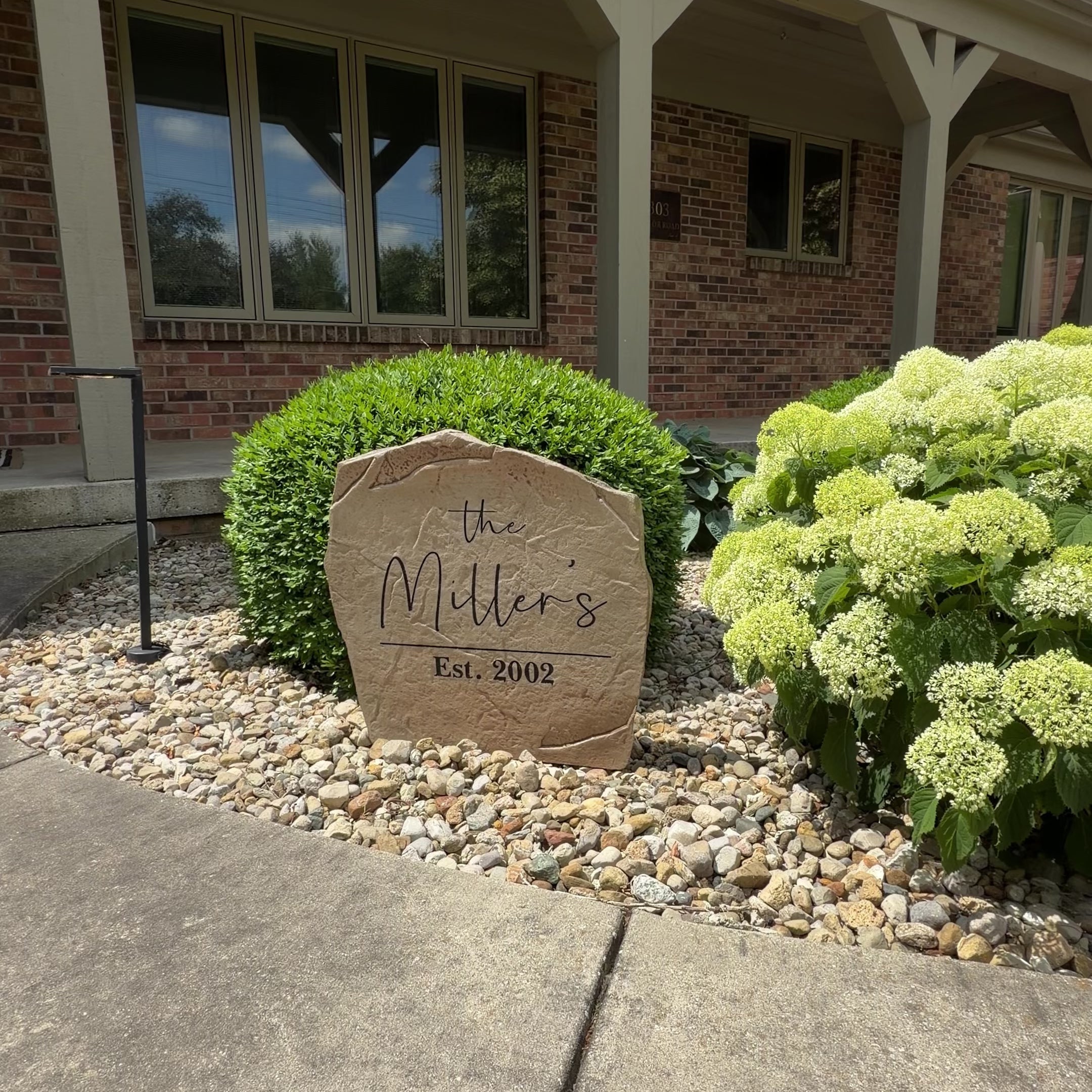 Engraved Modern Name Stone with a sleek, minimalist design and personalized lettering. This decorative garden stone enhances front yard landscaping and provides lasting beauty with its weather-resistant construction.