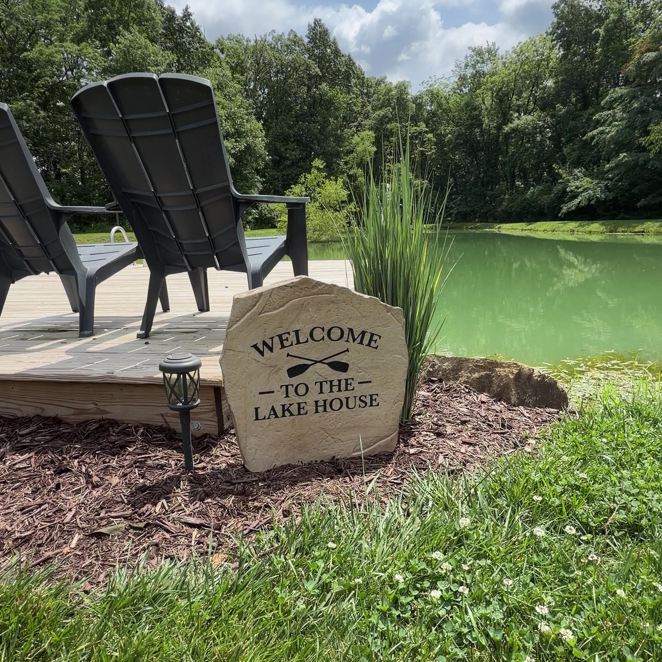 Video showcasing the Welcome to the Lake House Stone, a personalized engraved welcome stone with a relaxed lake-inspired design. Displayed outdoors to highlight its timeless beauty, durable craftsmanship, and the warm curb appeal it brings to a lake house entryway, garden, patio, or front yard.