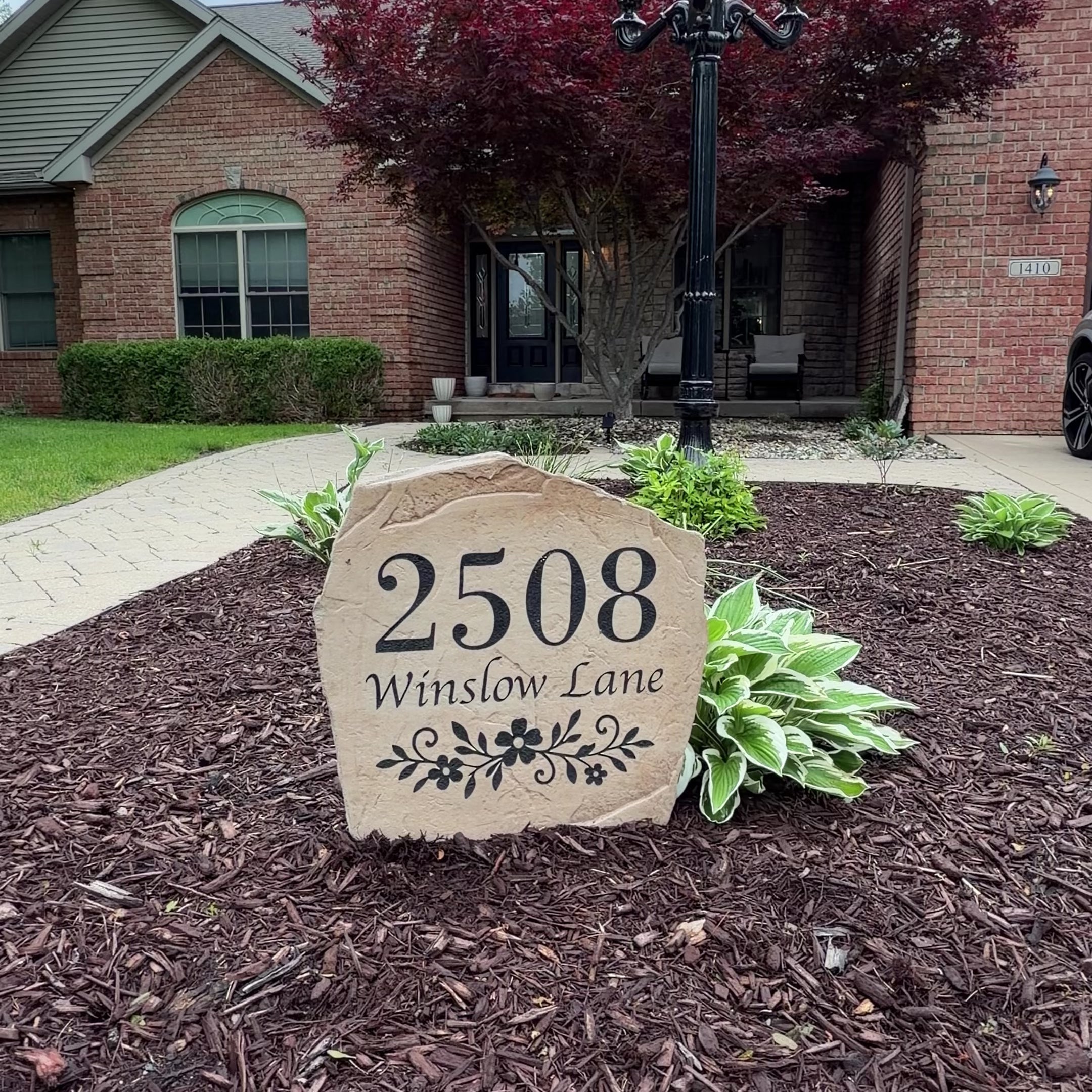 Custom Floral Address Stone with personalized house numbers and decorative floral accents, engraved directly into the stone for a permanent, weather-resistant finish. This personalized address stone enhances curb appeal and serves as a beautiful house number marker for front yards, gardens, driveways, and entryways, adding timeless elegance to any landscape.
