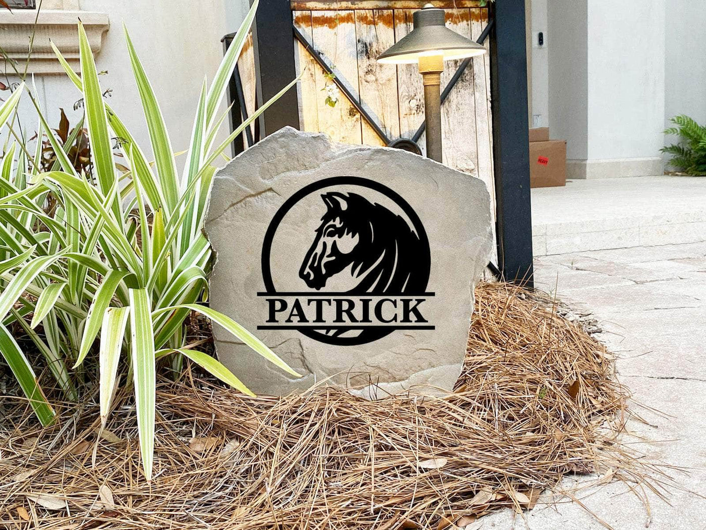 Western-style rock with engraved horse emblem and family name