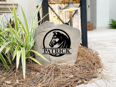 Western-style rock with engraved horse emblem and family name