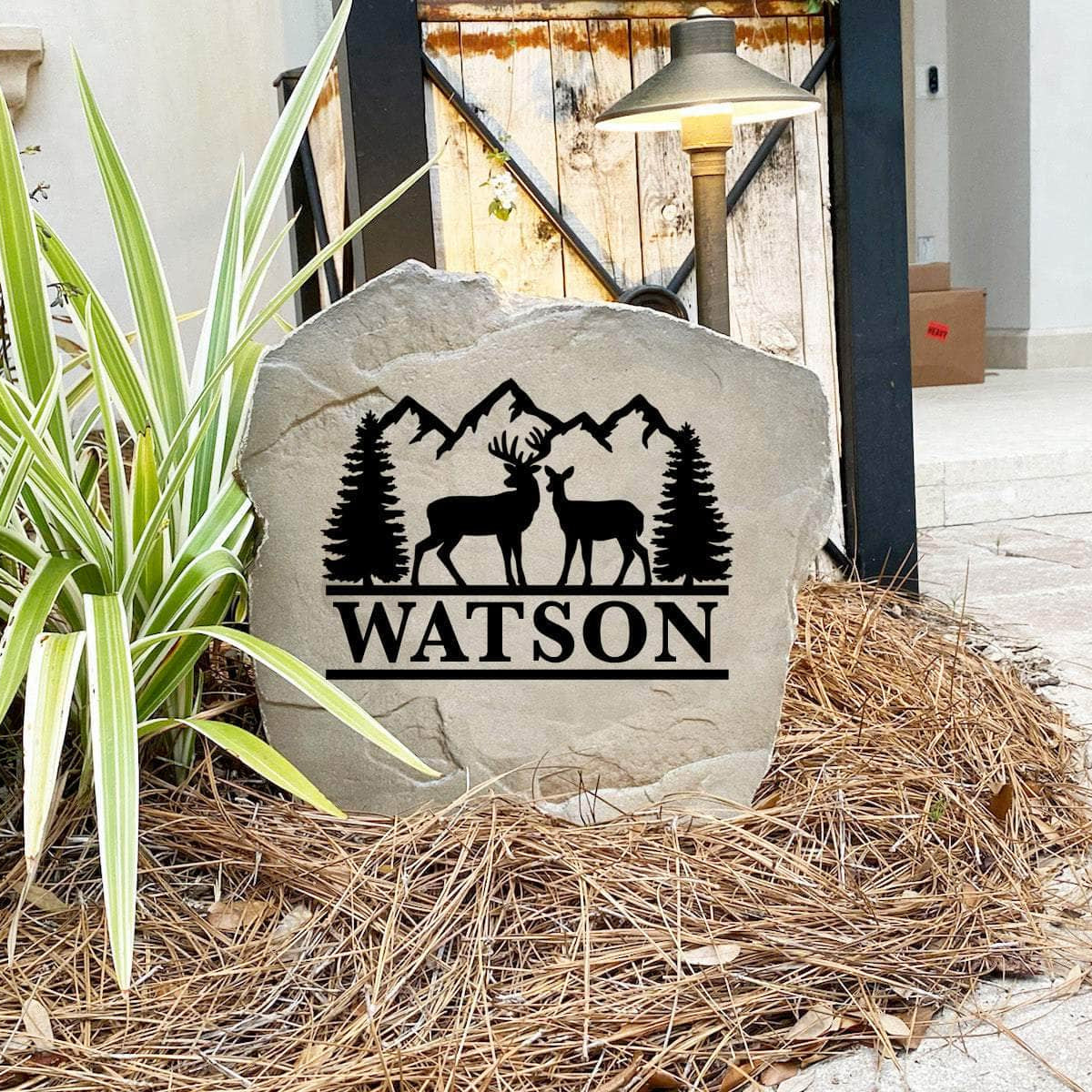 Engraved Deer Mountain Name Stone nestled among natural greenery and colorful flowers, bringing wilderness beauty and personalized style to front yard landscapes and outdoor living spaces.