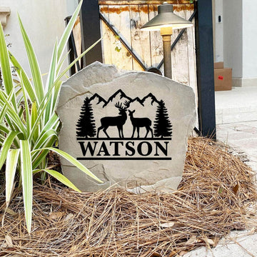 Engraved Deer Mountain Name Stone nestled among natural greenery and colorful flowers, bringing wilderness beauty and personalized style to front yard landscapes and outdoor living spaces.
