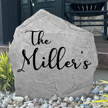 Personalized Script Name Stone engraved with your family name in elegant script lettering, creating a timeless landscape feature for your home.