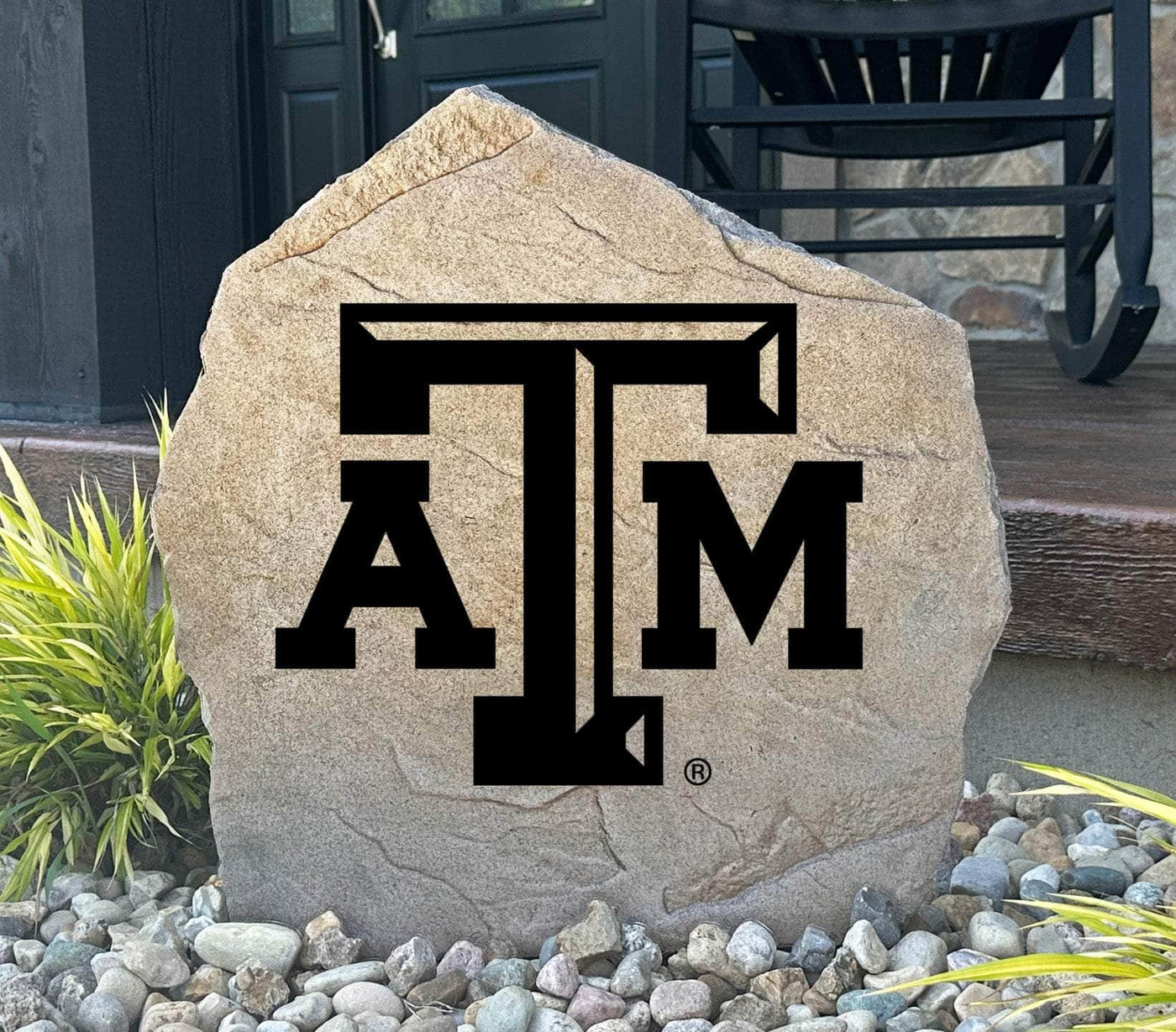 Texas A&M University logo stone placed in front yard landscaping